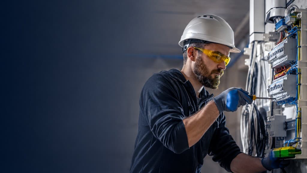 Electrical contractor safely repairing a residential electrical panel